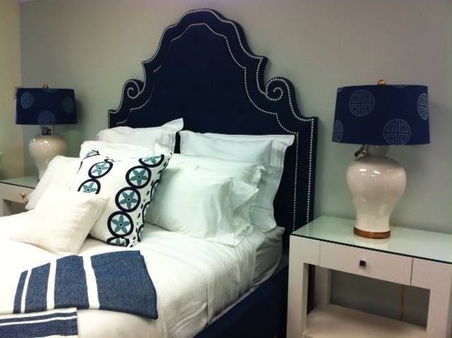 curved ornate keystone headboard in navy with nailhead trim via Pineapples Palms