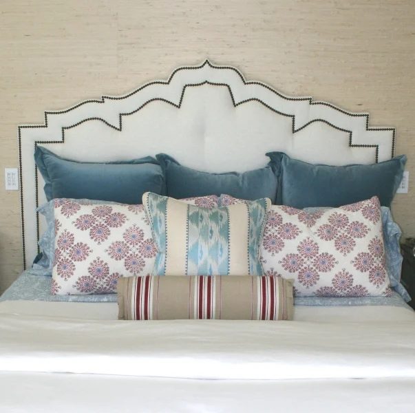 custom ornate arched trellis headboard with nailhead trim via Newport Harbor Home Tour