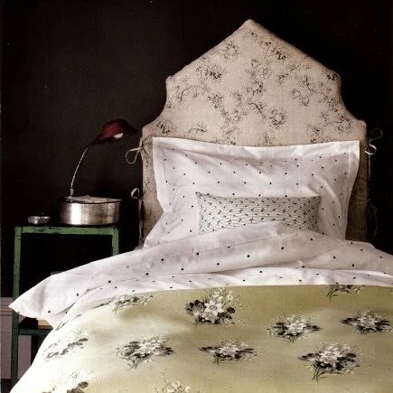 scooped peaked upholstered headboard via Attic Mag