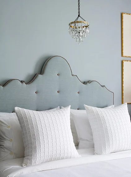 blue linen ornate camelback crown headboard with contrast blue trim and tufting buttons via DecorPad