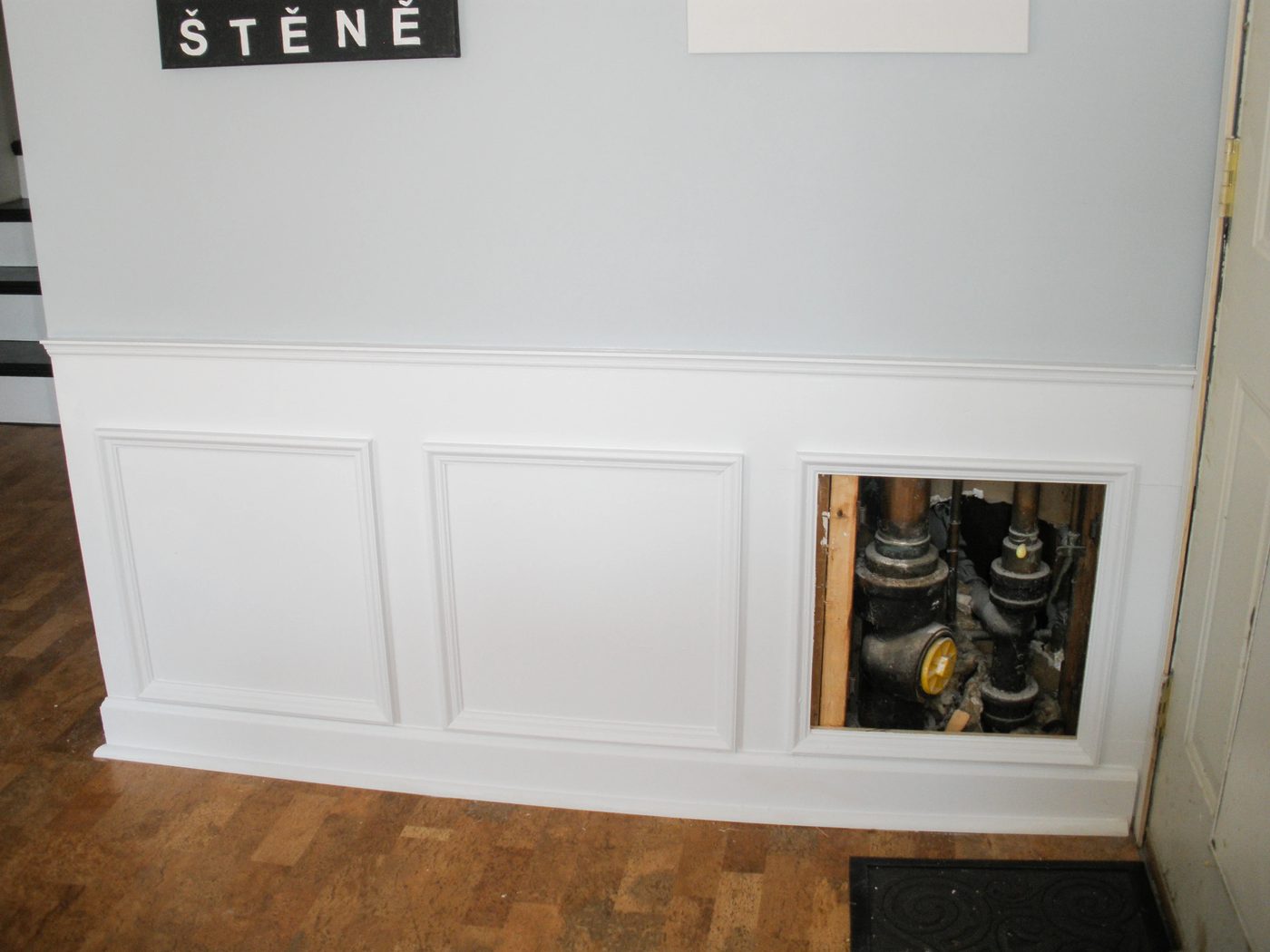 Hiding plumbing access with wainscoting-6