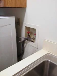 hide plumbing access in laundry room, featured on Bekob