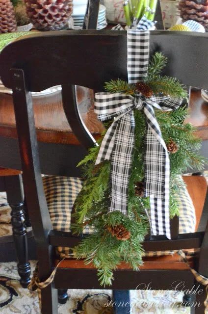 use pine garland and fabric to decorate dining chairs for holiday - Stonegable Blog via @Bekob