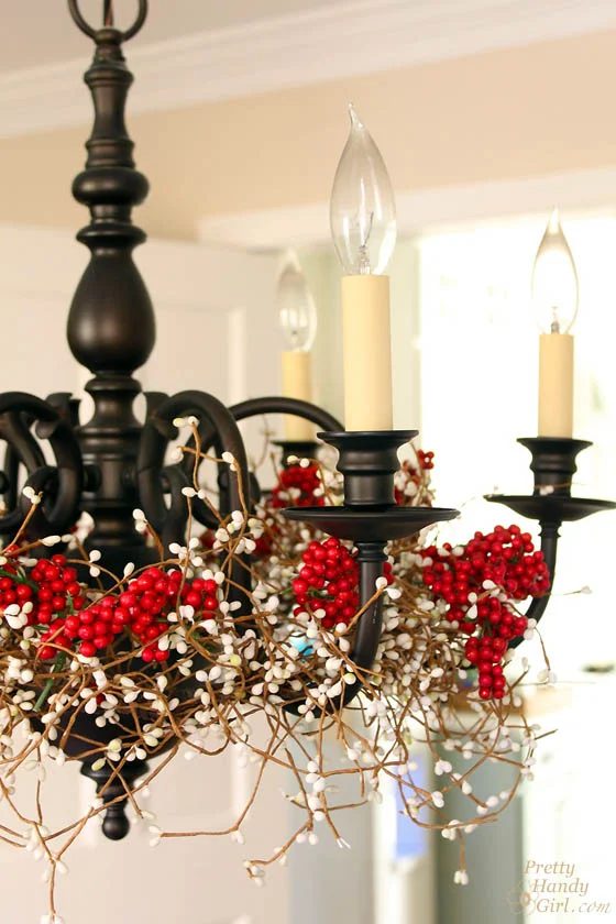 wrap holly berry and pine garlands around the chandelier - Pretty Handy Girl via @Bekob