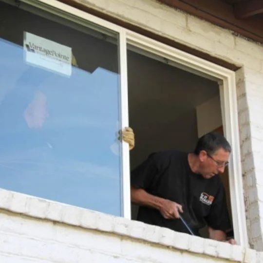 Help When SHopping For New Windows, Brick Building With Man Working On The Window