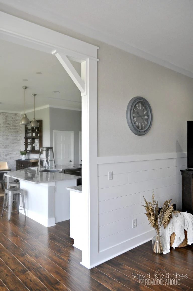 Stained Hardwood Floors With White Plank Walls On Botom Half, Cream Paint And Metal Accents