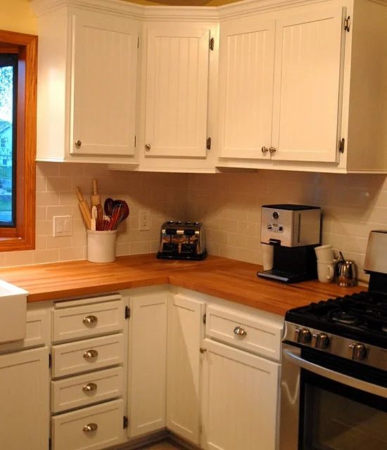 beadboard-kitchen-cabinet-doors-with-butcher-block-counters-subway-tile-backsplash