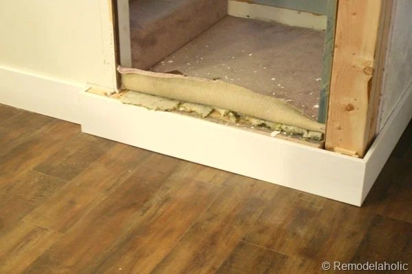 building out stair with wood bullnose and house numbers under barn door (2)