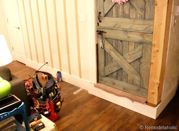 building out stair with wood bullnose and house numbers under barn door (3)