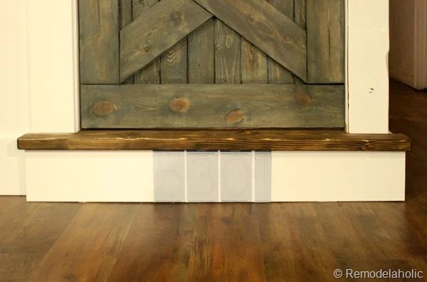 building out stair with wood bullnose and house numbers under barn door (12)