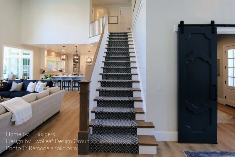 Half Open Staircase With Dark Gray Diamond Trellis Carpet Stair Runner On Wood Treads With Barn Door, Bekob UV19 H20