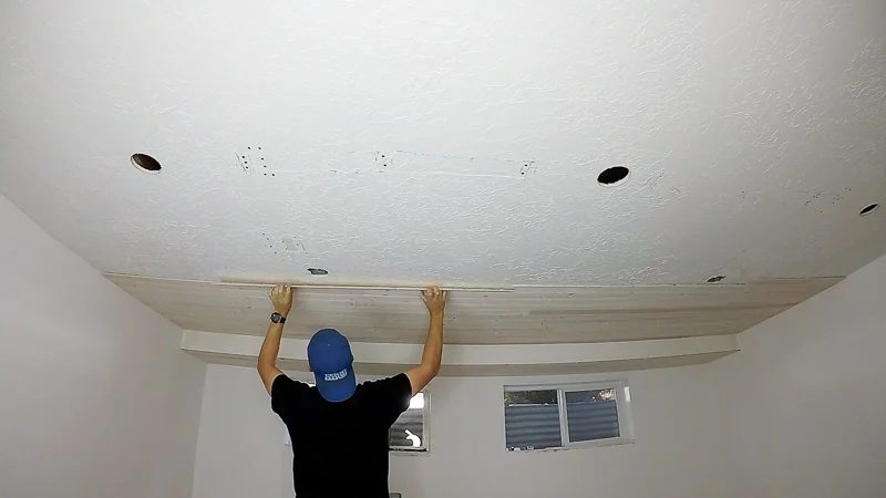 Installing Whitewashed Knotty Pine Boards On Ceiling for a Basement Plank Ceiling