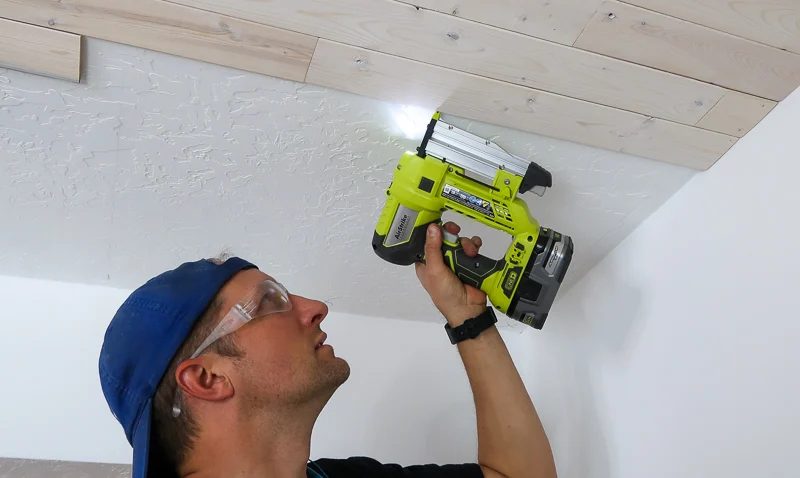 Installing Whitewashed Knotty Pine Boards On Ceiling Nailing With Pin Nailer