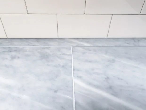 striking combination! Tiled marble countertops and white subway tile backsplash, both DIYed over existing finishes
