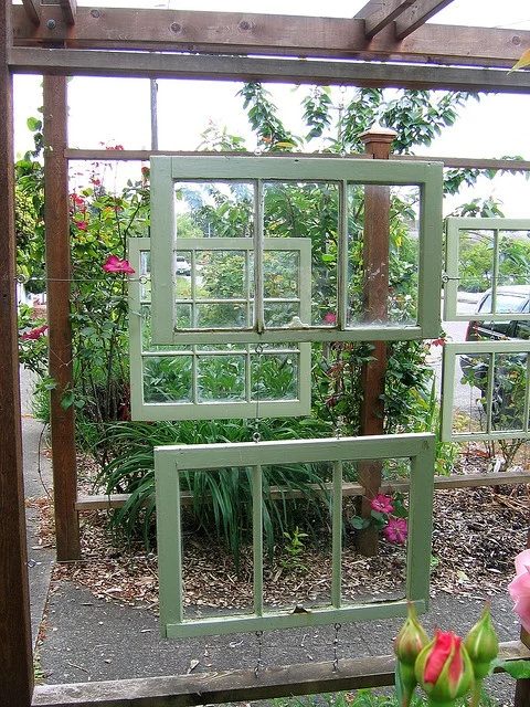 Flickr user lifebegreen - windowed arbor in garden path - via Bekob