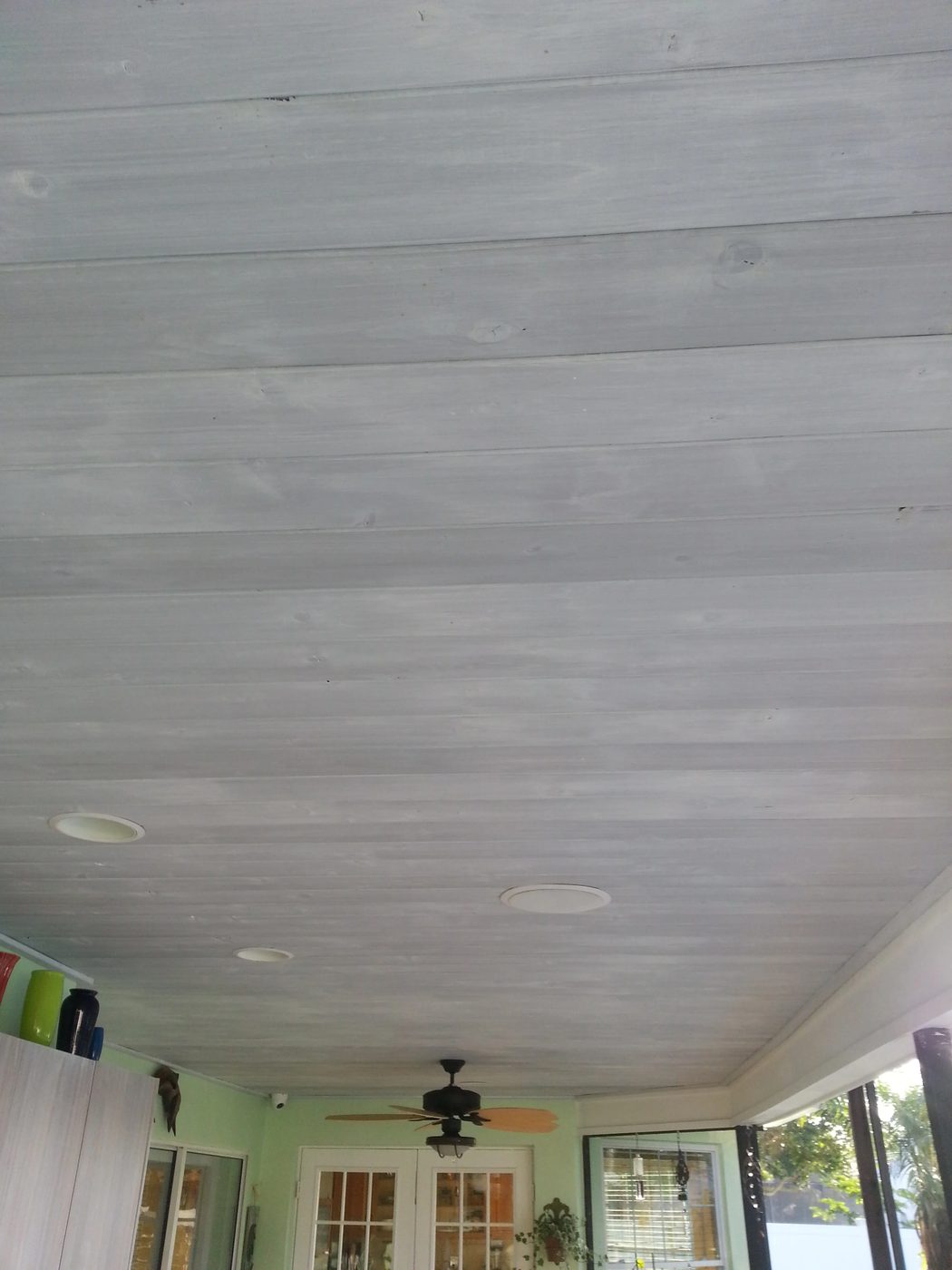 whitewashed wood ceiling over gray stain