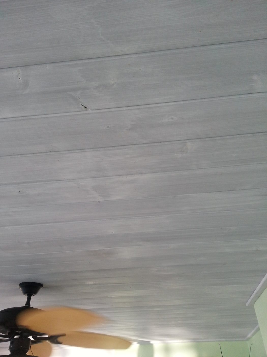 whitewashed wood over gray stained ceiling