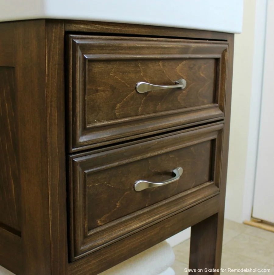 Build a small vanity with an IKEA sink -- and it has both open storage on the bottom AND a hidden storage cabinet behind two false drawer fronts.