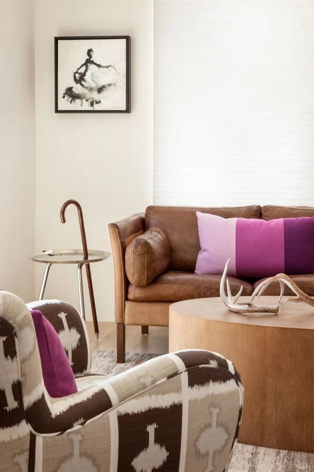 vivid living room with leather sofa and round solid wood slab coffee table by Violante & Rochford Interiors, photo credit © Wendy McEahern
