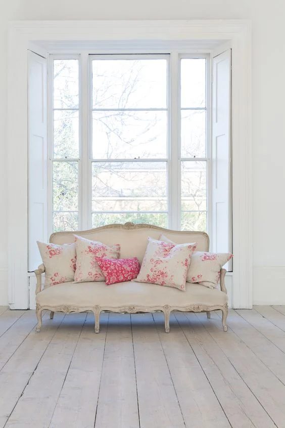 French couch with pretty pink floral pillows by Cabbage & Roses