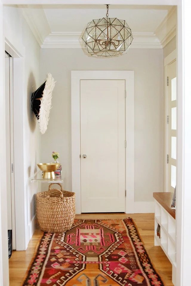 That rug is memorable, and I love the light in this entry hall! I need a shoe cubby bench, too. | 100+ striking Mudrooms and Entryways at Bekob.com