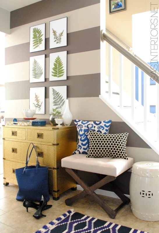 Gold and navy entryway, love the bench and plant prints | 100+ striking Mudrooms and Entryways at Bekob.com