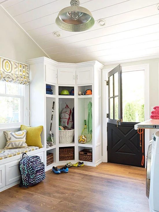 Large white mudroom with a corner storage locker unit and a Dutch door. Adding to my dream house list! | 100+ striking Mudrooms and Entryways at Bekob.com