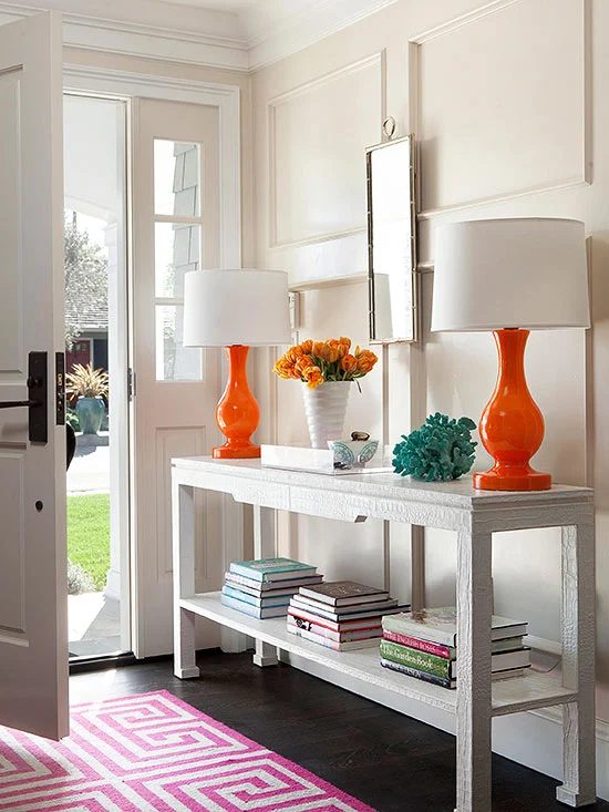 Neutral walls and furnishings but still so much COLOR in this entryway. Those orange lamps are solid! | 100+ striking Mudrooms and Entryways at Bekob.com