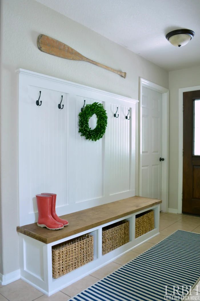 white mudroom cubbies with hooks, love the paneling to set it apart on the wall | 100+ striking Mudrooms and Entryways at Bekob.com