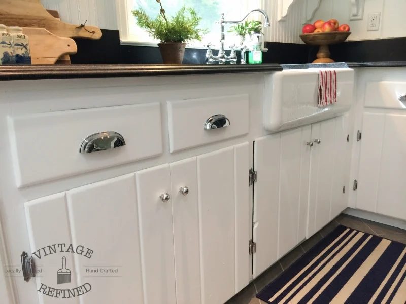 Chrome drawer pulls maintain classic feel in lakehouse kitchen remodel, black and white kitchen, by Vintage Refined featured on @Bekob