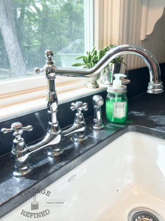 Chrome fixtures in remodeled black and white kitchen, by Vintage Refined featured on @Bekob