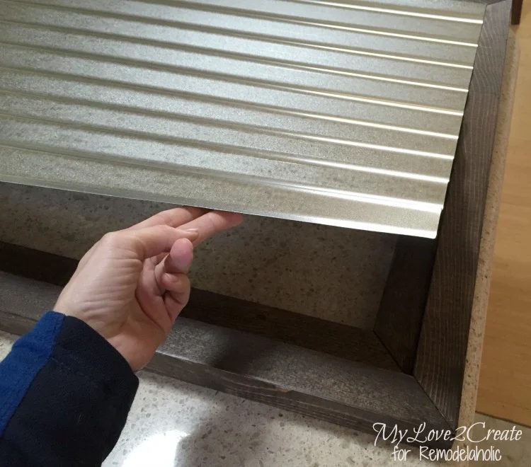 placing corrugated metal inside wood frame