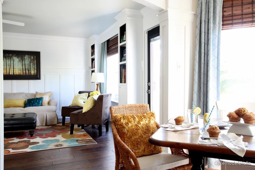 Living Room Remodel with yellow accents wood floors and built-in bookcases and columns with arches-4