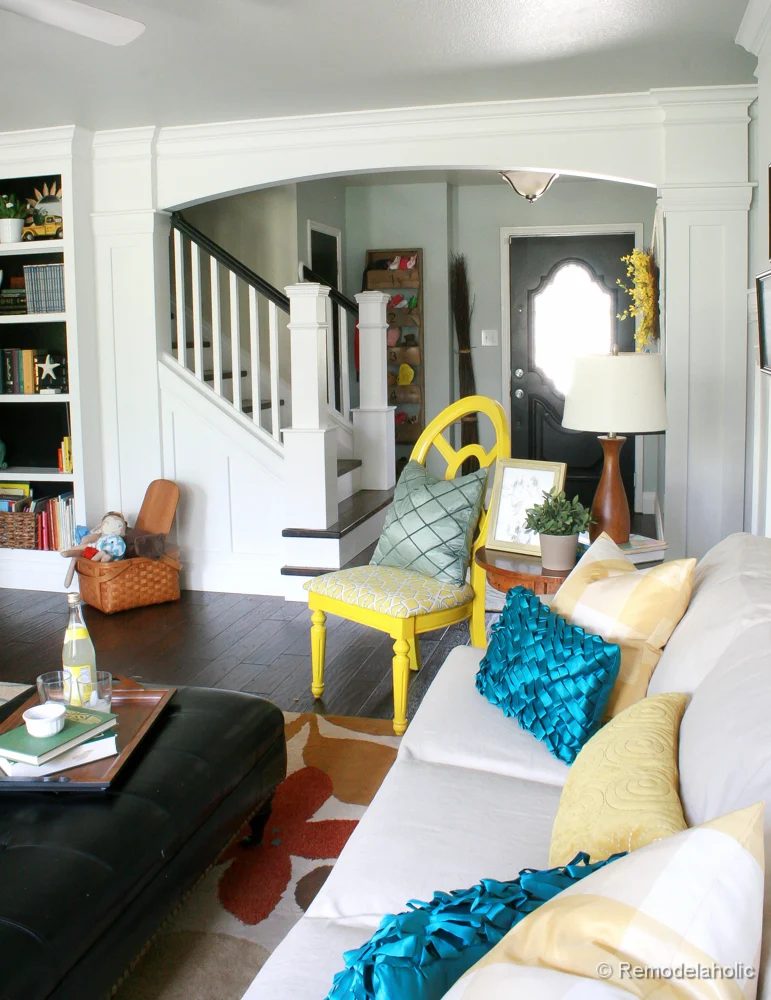 Living Room Remodel with yellow accents wood floors and built-in bookcases and columns with arches-28