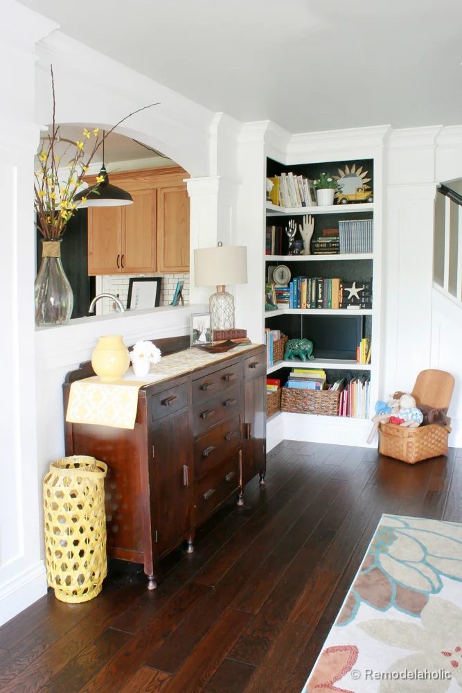 Living Room Remodel with yellow accents wood floors and built-in bookcases and columns with arches-21