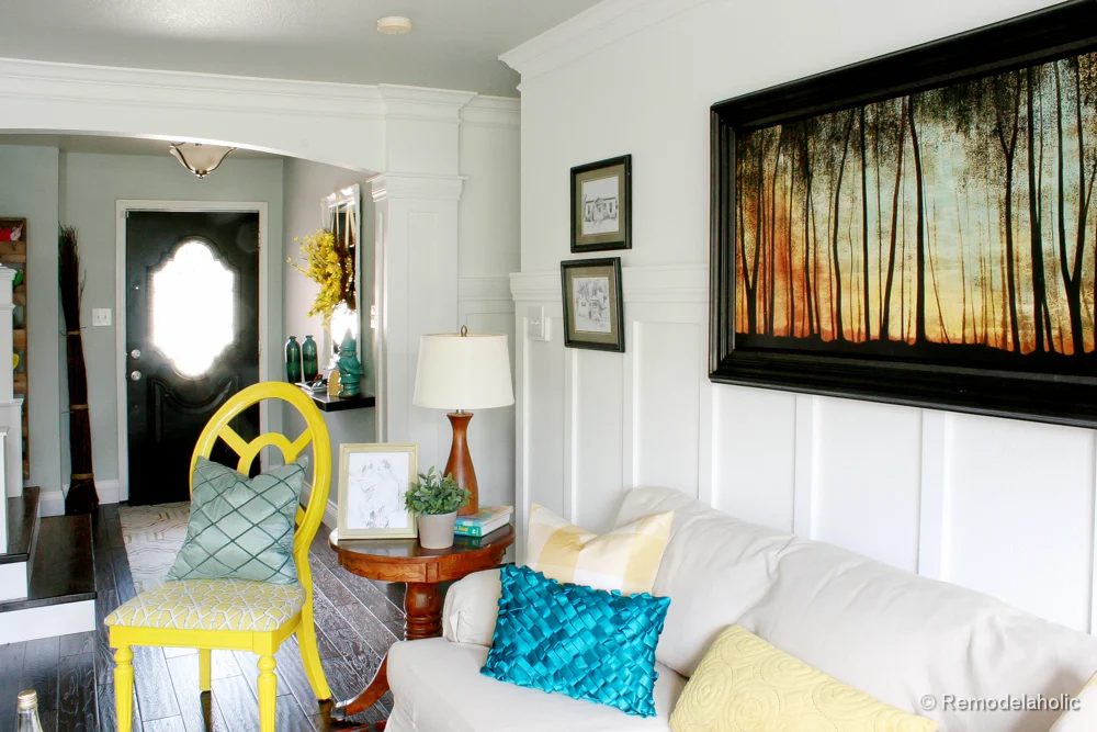 Living Room Remodel with yellow accents wood floors and built-in bookcases and columns with arches-25