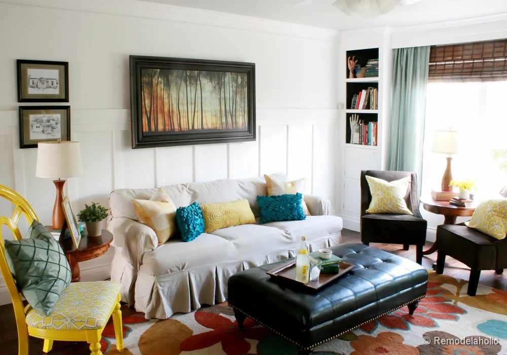 Living Room Remodel with yellow accents wood floors and built-in bookcases and columns with arches-16