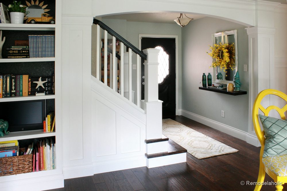 Living Room Remodel with yellow accents wood floors and built-in bookcases and columns with arches-33