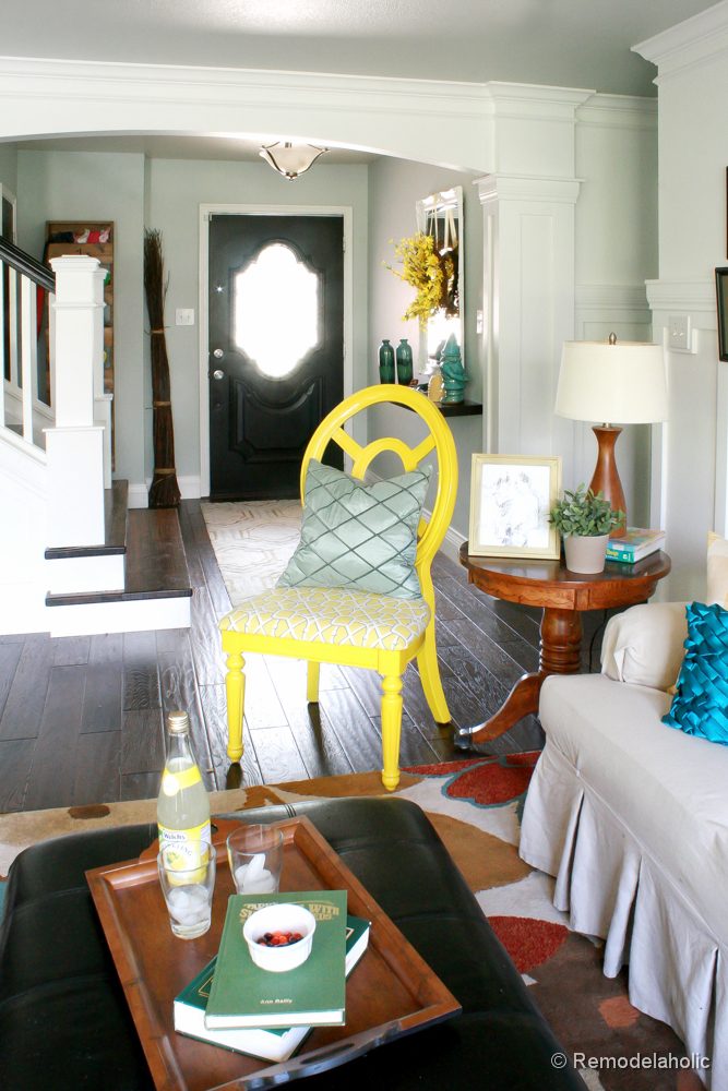 Living Room Remodel with yellow accents wood floors and built-in bookcases and columns with arches-20