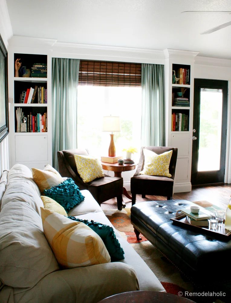Living Room Remodel with yellow accents wood floors and built-in bookcases and columns with arches-36