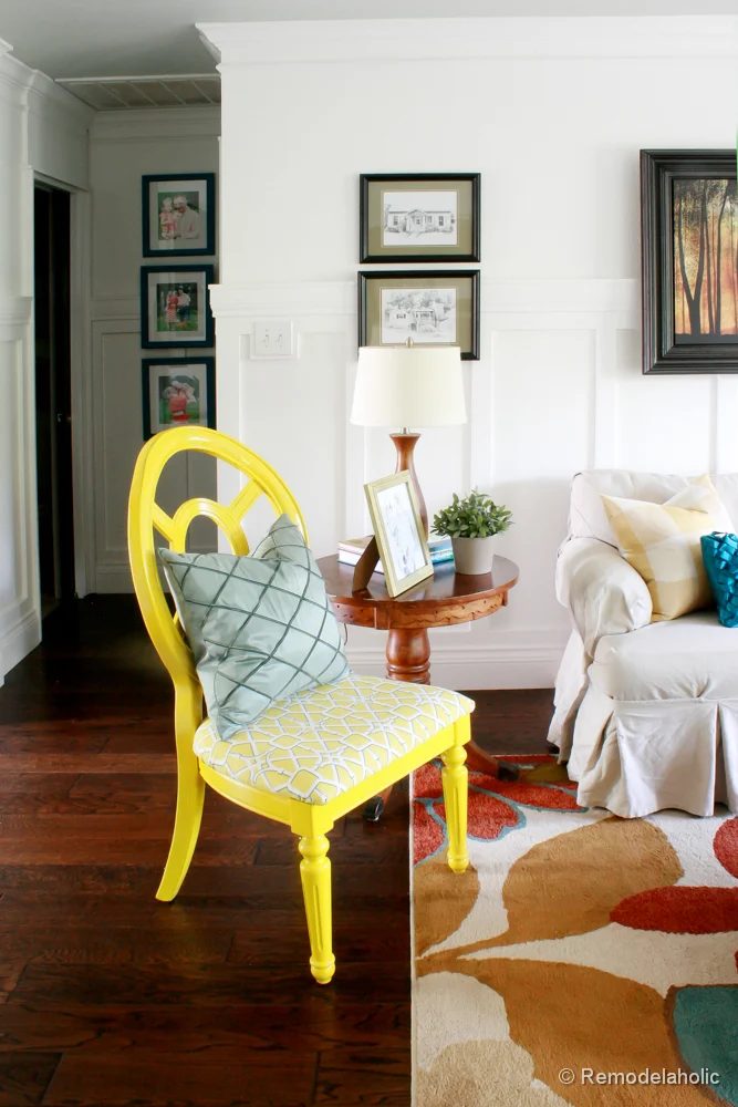 Living Room Remodel with yellow accents wood floors and built-in bookcases and columns with arches-19