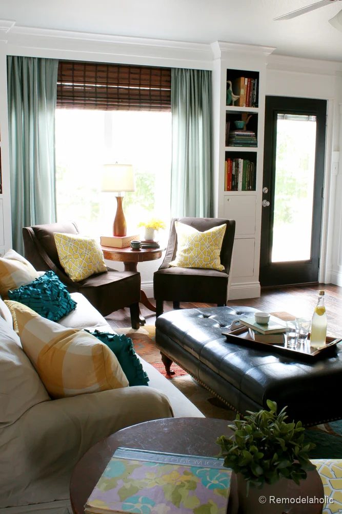 Living Room Remodel with yellow accents wood floors and built-in bookcases and columns with arches-38