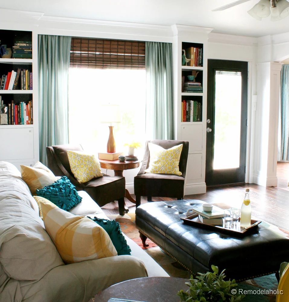 Living Room Remodel with yellow accents wood floors and built-in bookcases and columns with arches-37