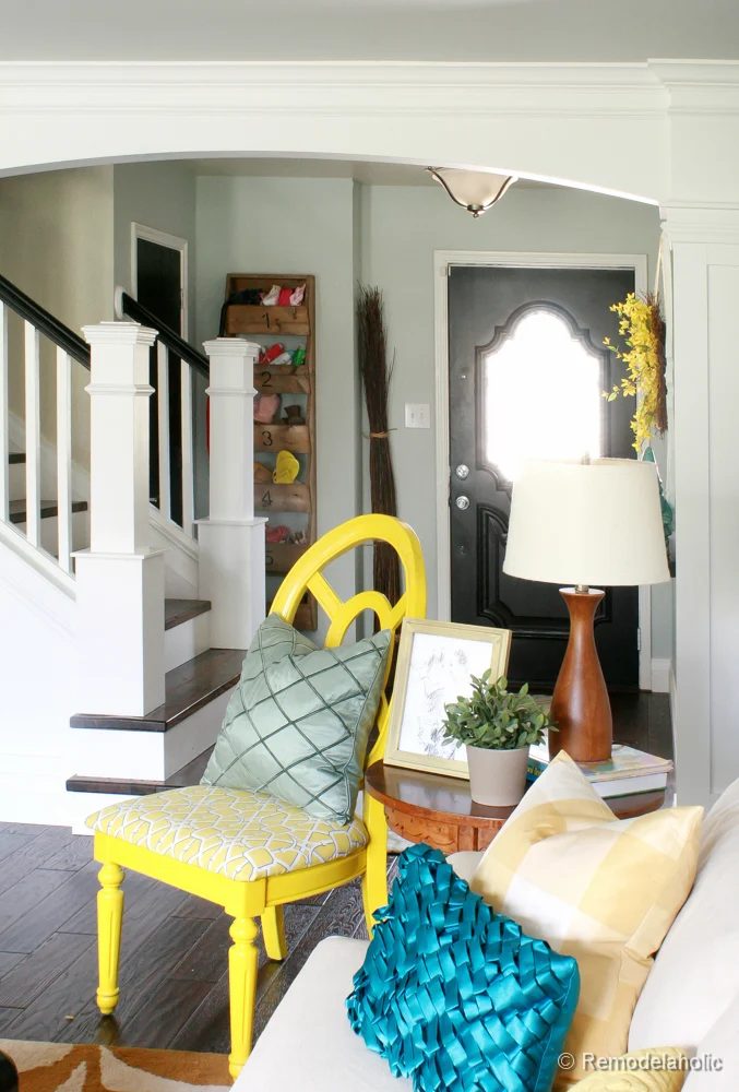 Living Room Remodel with yellow accents wood floors and built-in bookcases and columns with arches-27