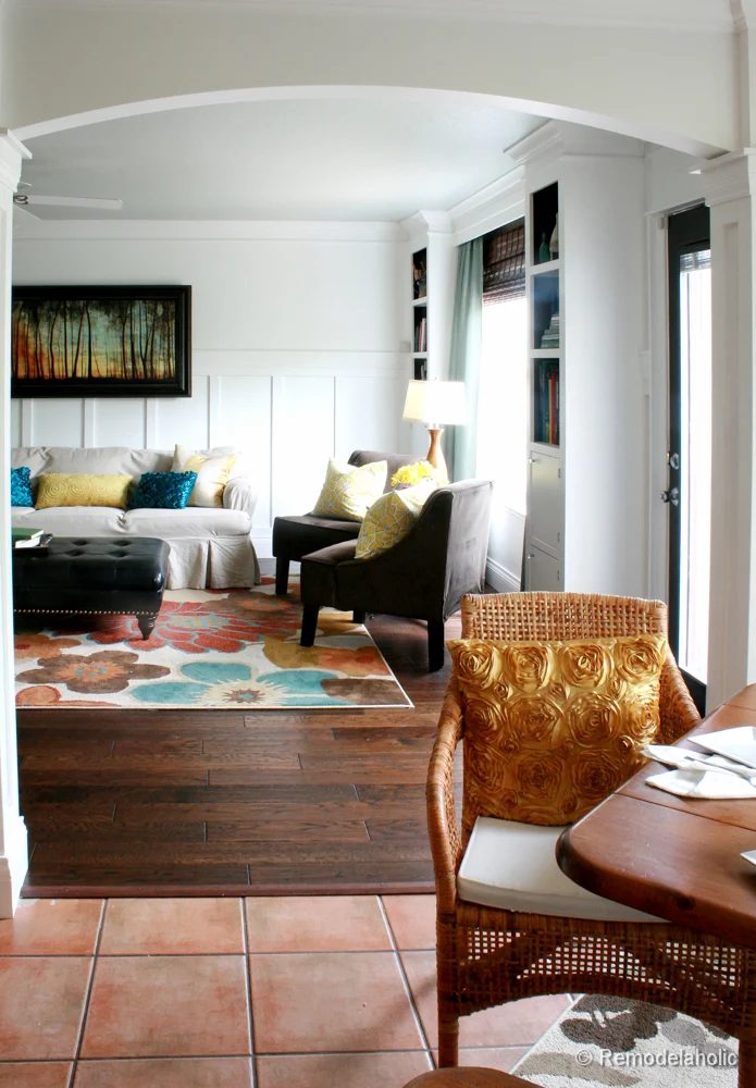 Living Room Remodel with yellow accents wood floors and built-in bookcases and columns with arches-11