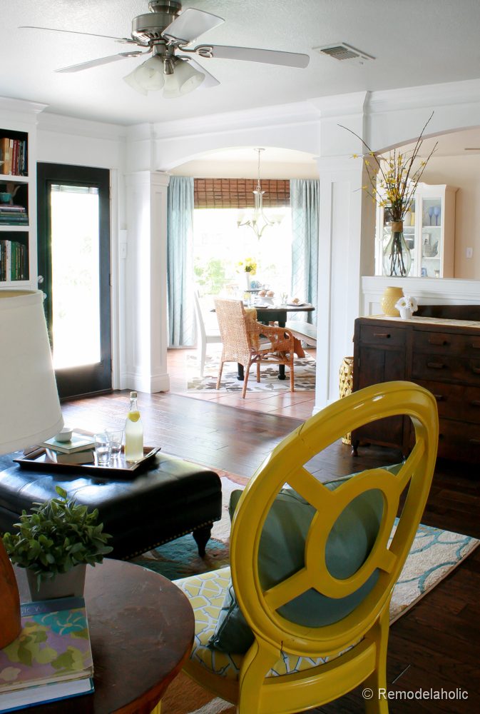 Living Room Remodel with yellow accents wood floors and built-in bookcases and columns with arches-34