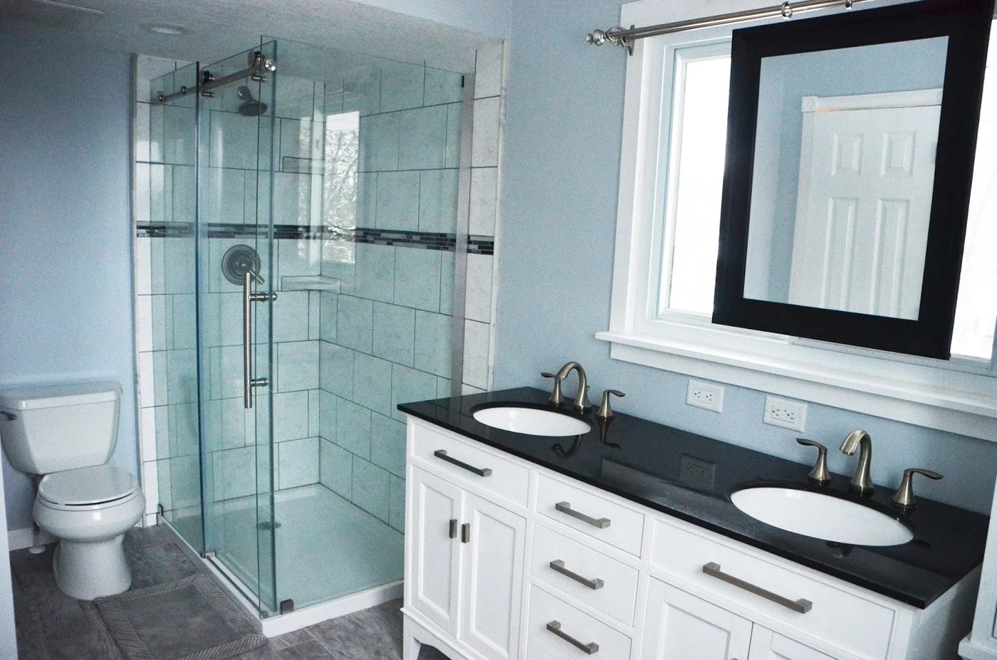 Bathroom Renovation with sliding mirror over window, dark vanity countertop over white vanity, by Since I Became a Mom featured on @Remodelohic