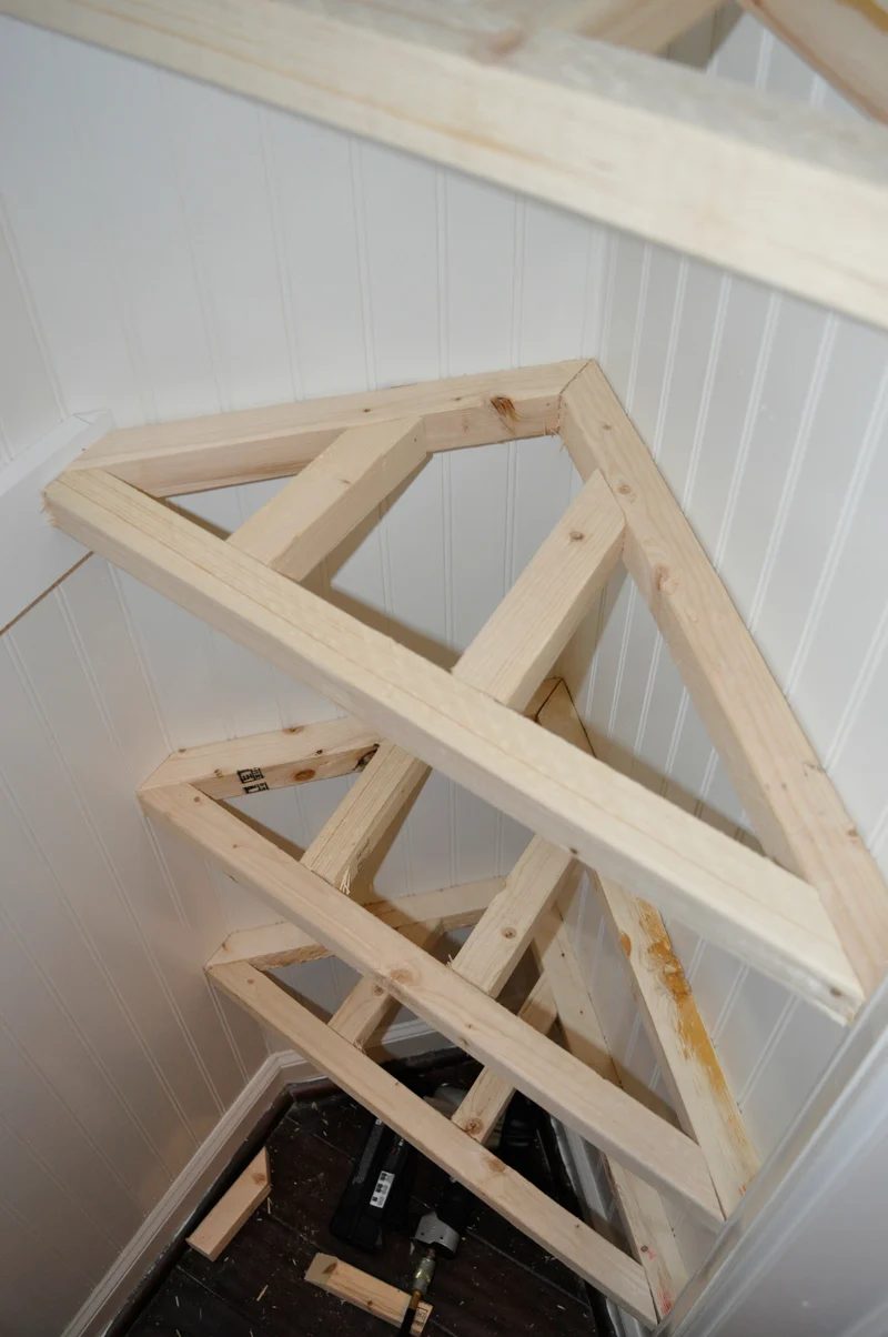 adding odd shaped floating shelves in the corner of a hall coat closet