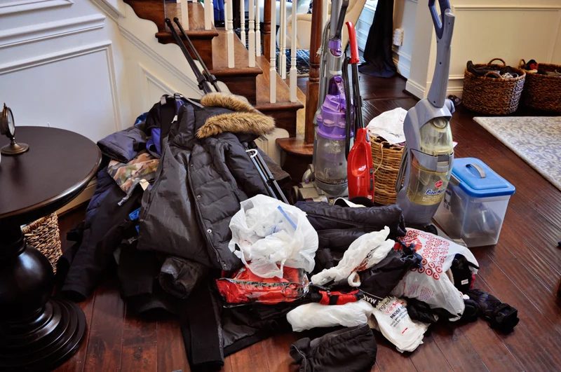 hall closet organization to store vacuum, coats, backpacks, and more