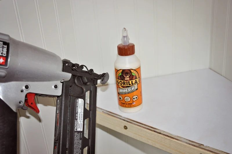 attach floating corner shelf top with wood glue and brad nails